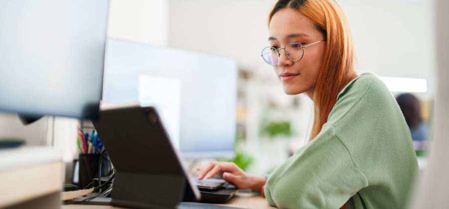 Women with glasses at laptop at desk