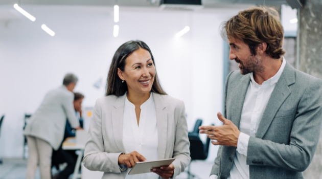 Two business leaders smiling with tablet