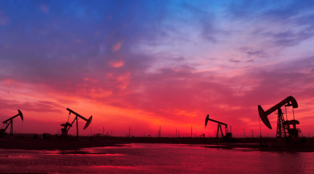 Oil and gas wells at sunset