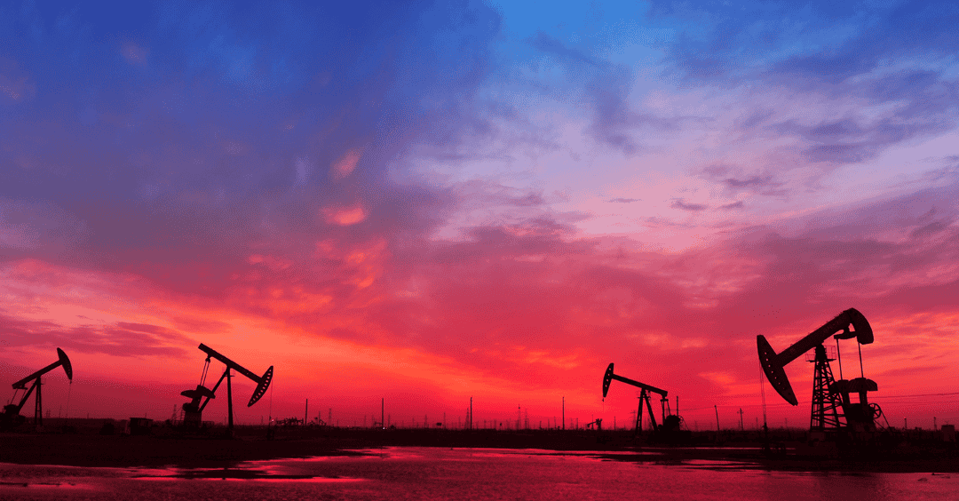 oil and gas wells at sunset